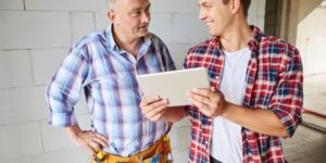 Carpenter and apprentice working on a project